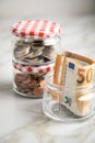 3 glass jars with Euro notes, 2Ã¢âÂ¬ coins and loose cash for housekeeping and savings Royalty Free Stock Photo